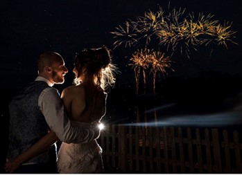 Image of bride and groom watching fireworks