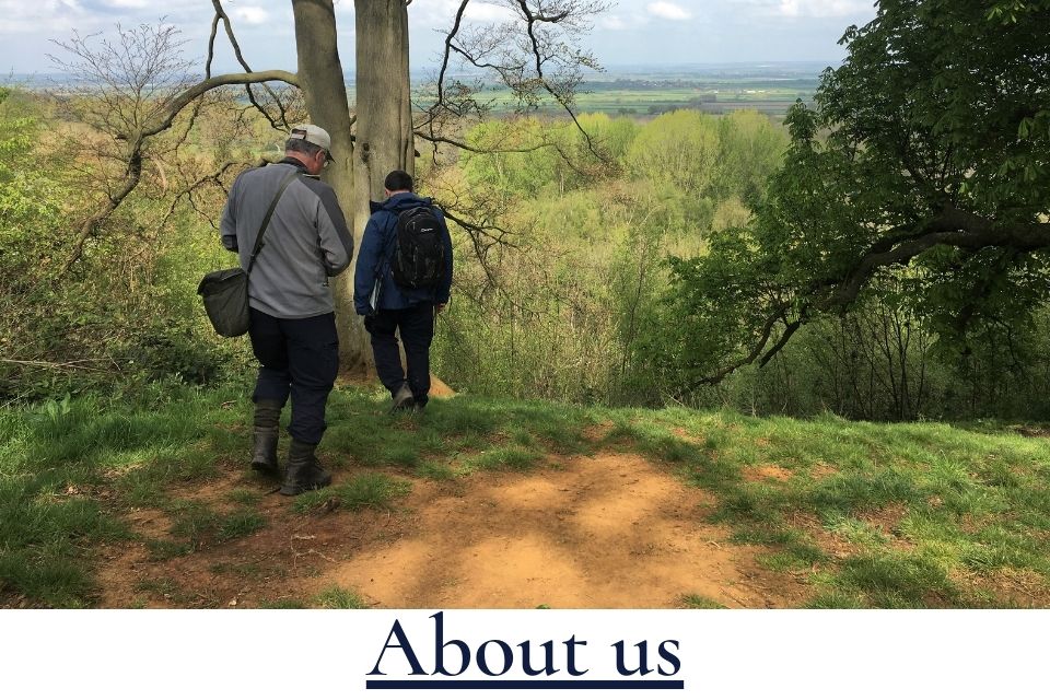 Image of two men walking into the countryside